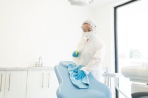 disinfecting dental clinic while wearing suit